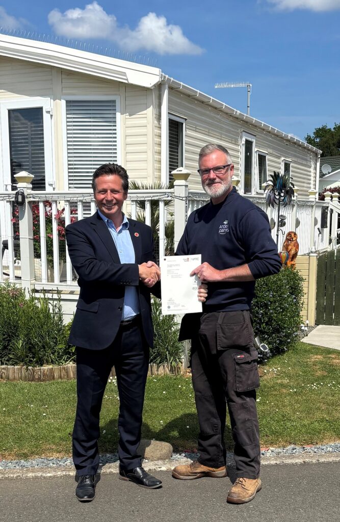 Nigel Huddleston congratulates Ian Ward on attaining his chainsaw certificate